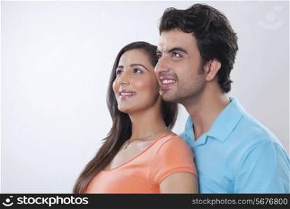 Young couple day dreaming over white background