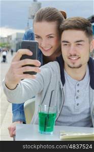 young couple doing a selfie at bar terrace