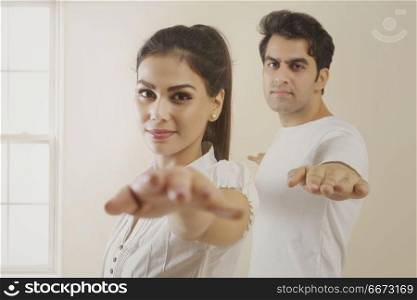 Young couple doing exercise stretching hands
