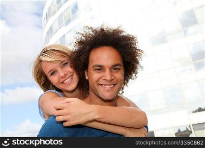Young couple doing piggyback outside