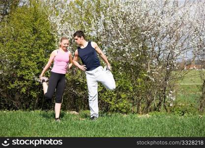 Young couple doing stretching exercises
