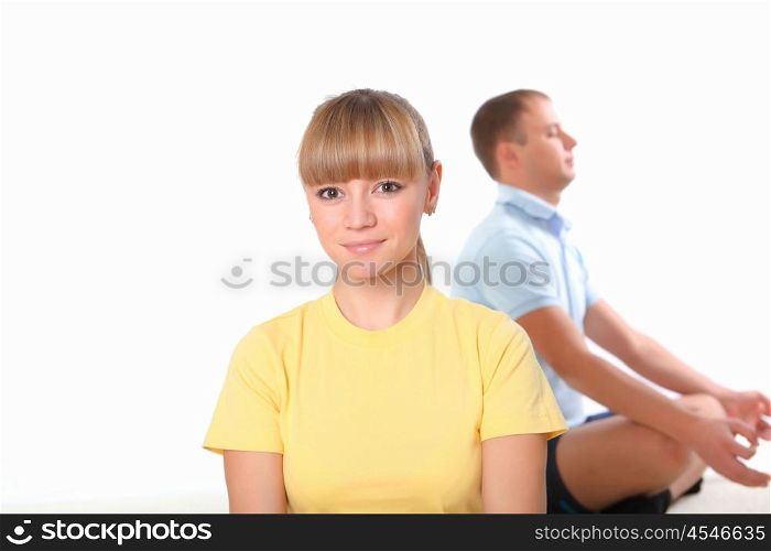 young couple doing yoga exercise together indoors