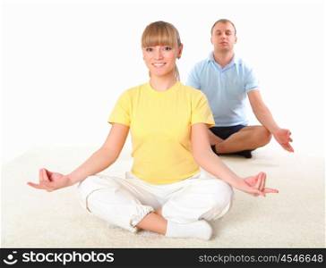 young couple doing yoga exercise together indoors