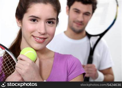Young couple dressed for tennis
