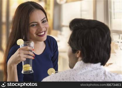 Young couple drinking lemon juice