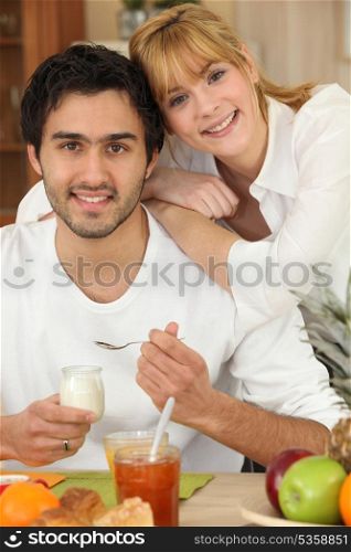 Young couple eating breakfast