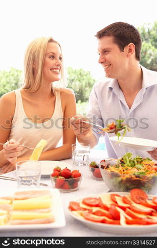 Young couple eating outdoors