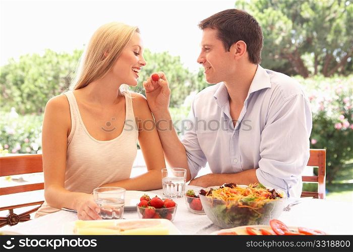 Young couple eating outdoors