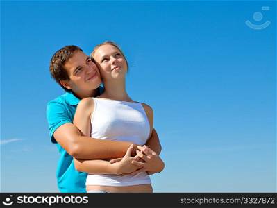 young couple embracing and looking in the sky