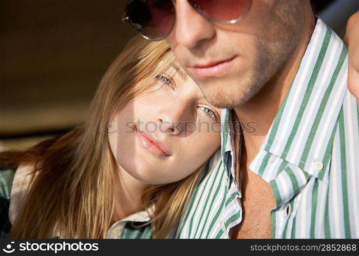 Young couple embracing head and shoulders
