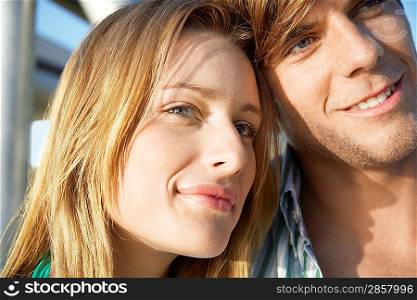 Young couple embracing head and shoulders
