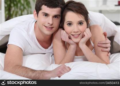 young couple embracing in bed