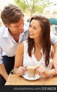 Young Couple Enjoying Coffee And Cake In CafZ