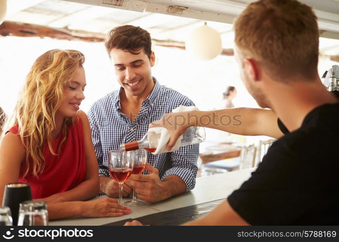 Young Couple Enjoying Drink At Outdoor Bar