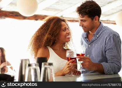 Young Couple Enjoying Drink At Outdoor Bar