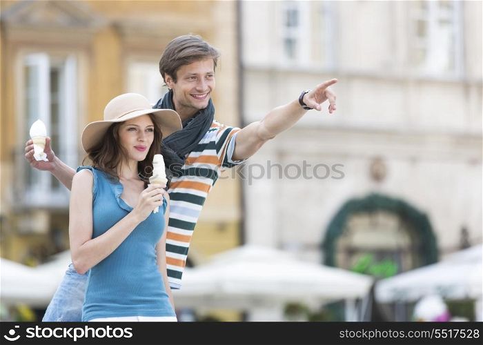 Young couple enjoying ice cream cones during vacation