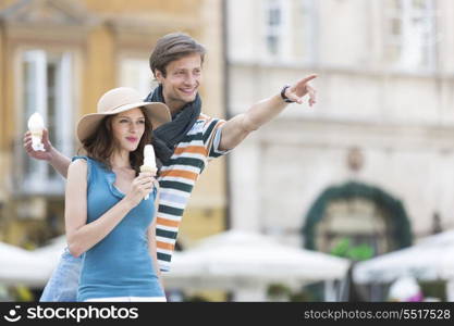 Young couple enjoying ice cream cones during vacation