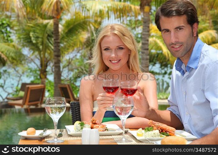 Young couple enjoying lunch in resort restaurant