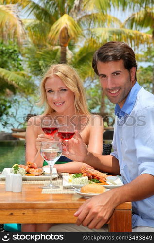 Young couple enjoying lunch in resort restaurant