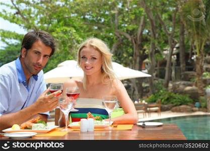 Young couple enjoying lunch in resort restaurant