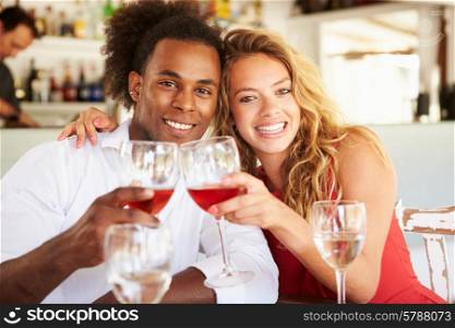 Young Couple Enjoying Meal In Outdoor Restaurant
