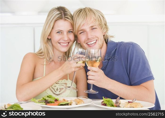 Young Couple Enjoying meal,mealtime With A Glass Of Wine