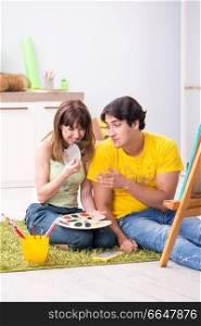 Young couple enjoying painting at home
