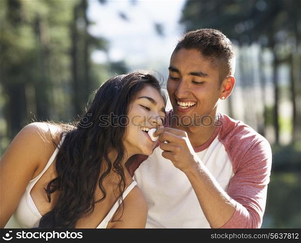 Young Couple Enjoying Picnic In Countryside