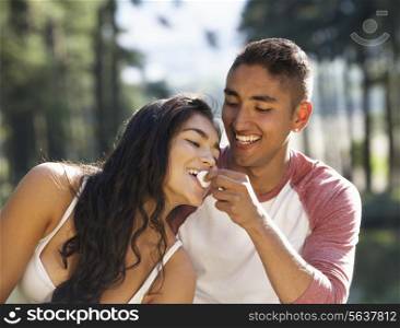 Young Couple Enjoying Picnic In Countryside