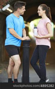 Young Couple Exercising In Urban Environment