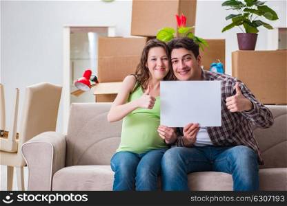 Young couple expecting baby with blank message