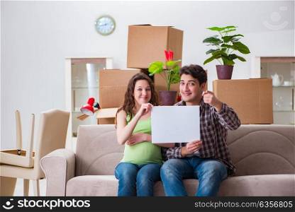 Young couple expecting baby with blank message