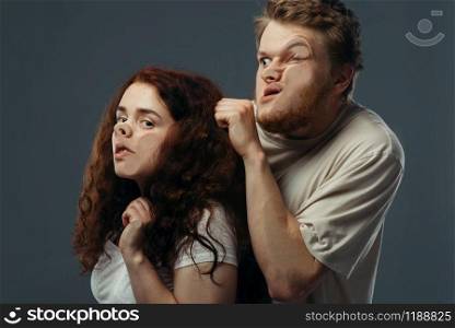 Young couple faces crushed on transparent glass, funny emotion. Man and woman with pressed grimaces standing at the showcase, humor, uncomfortable looking. Couple faces crushed on glass, funny emotion