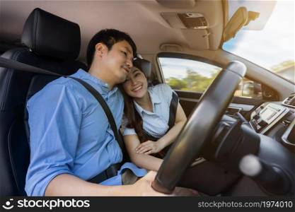 young couple feeling love together while driving a car