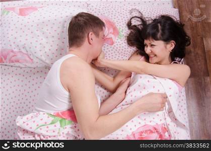 Young couple find out the relationship in bed