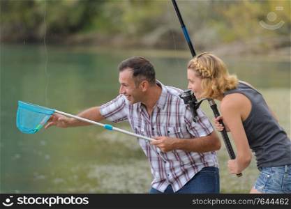 young couple fishing something