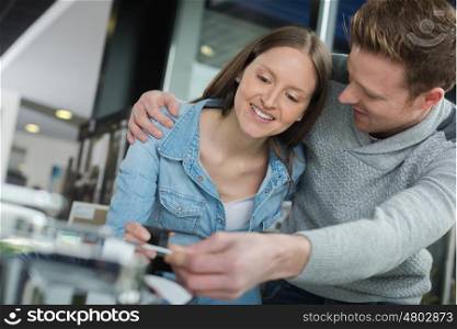 young couple fixing a devise at home