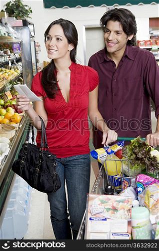 Young couple food shopping in supermarket