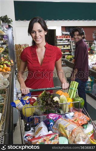 Young couple food shopping in supermarket