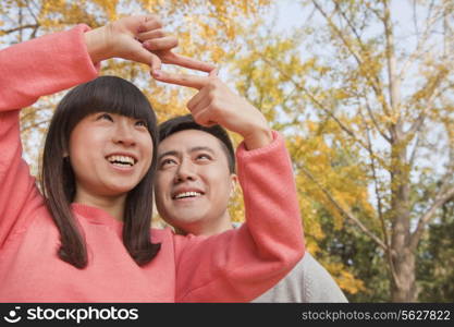 Young couple framing with fingers