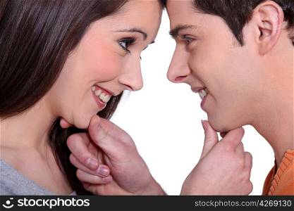 Young couple gazing lovingly into each other&acute;s eyes