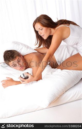 Young couple getting up in the morning, woman holding alarm clock