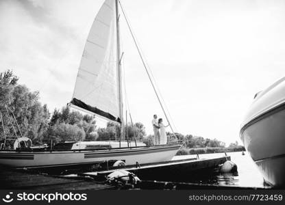 young couple guy and girl on a white sailing yacht