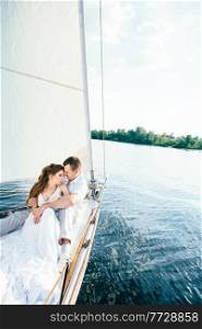 young couple guy and girl on a white sailing yacht