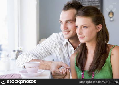 Young couple having a cold drink in a cafeteria
