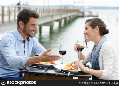 young couple having a lunch with bridge view