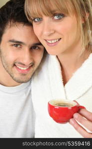 Young couple having an early morning cup of coffee