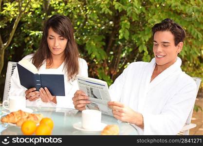 young couple having breakfast outdoors