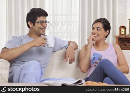 Young couple having coffee together at home