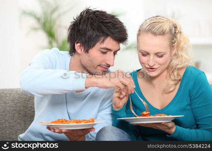 young couple having dinner at home